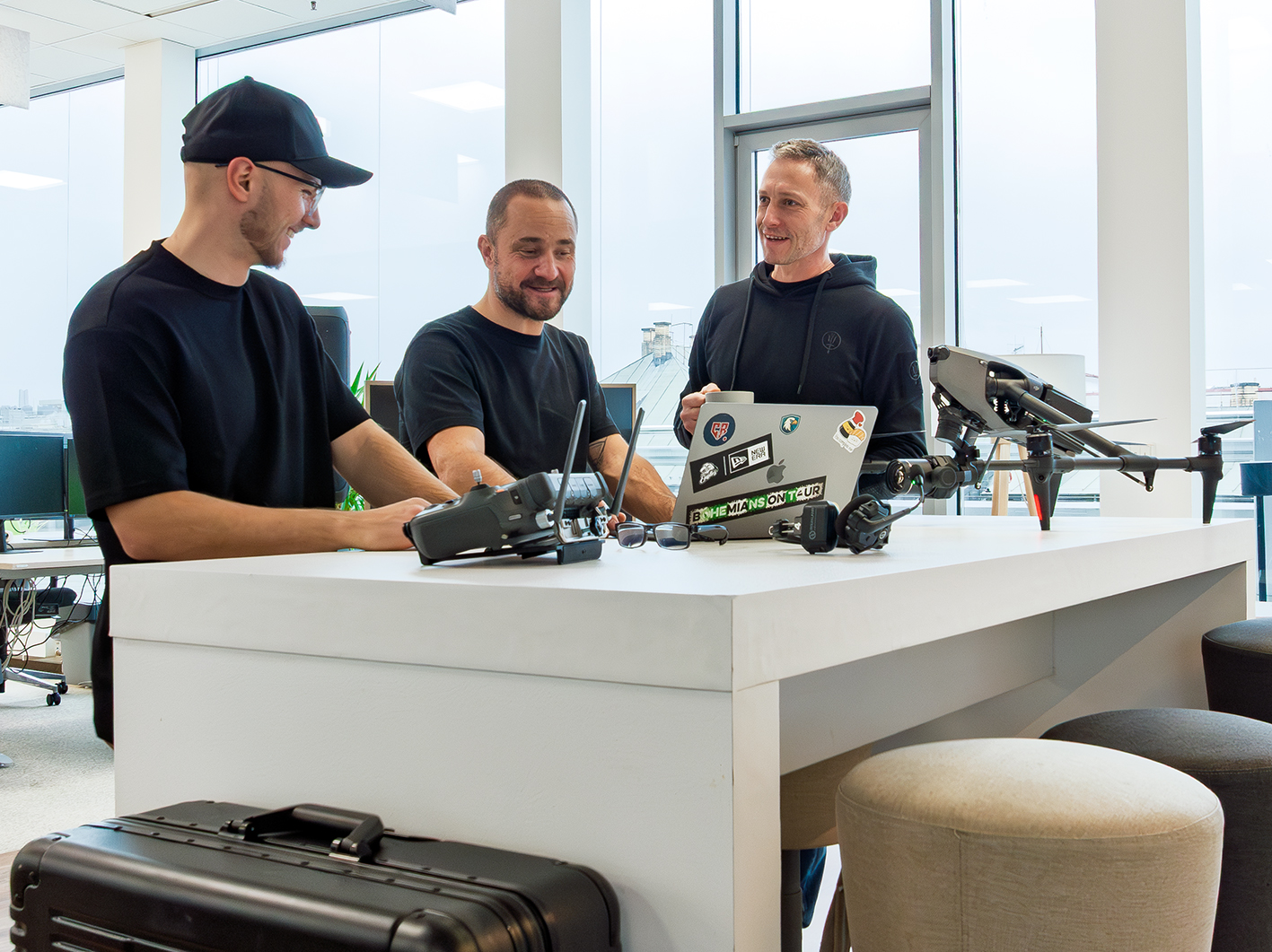Drone crew reviewing footage on set during a film shoot