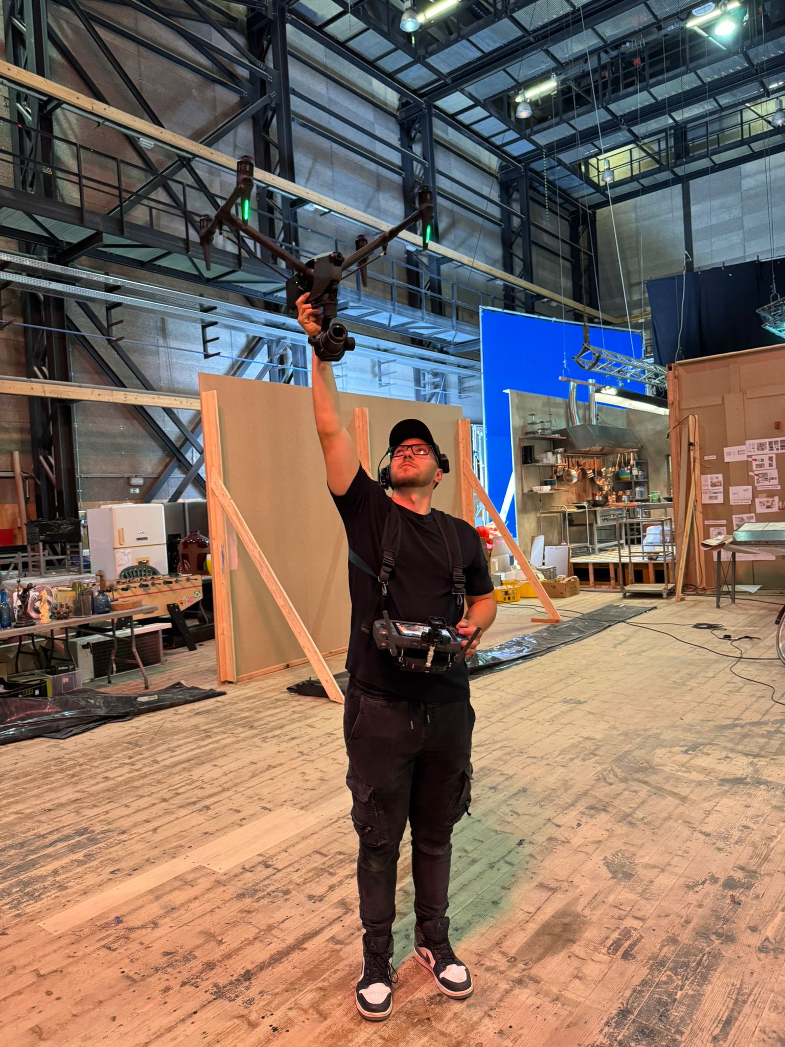 Drone pilot and film crew coordinating an aerial shot